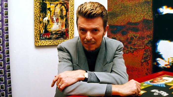 David Bowie showcasing his work at his first solo art exhibition in London during the 1990s.