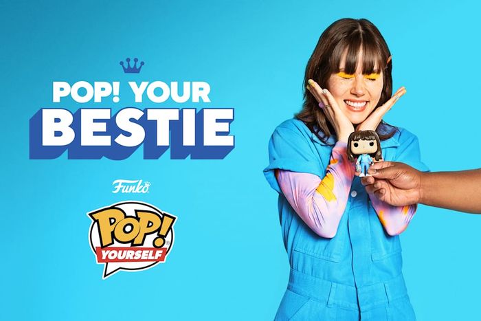 A thrilled girl proudly displays her personalized Funko Pop! figure