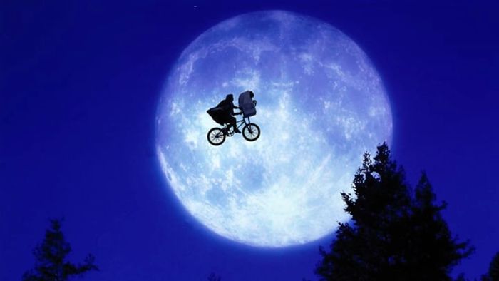 A scene captured from Steven Spielberg's iconic film, E.T. the Extra-Terrestrial (1982).