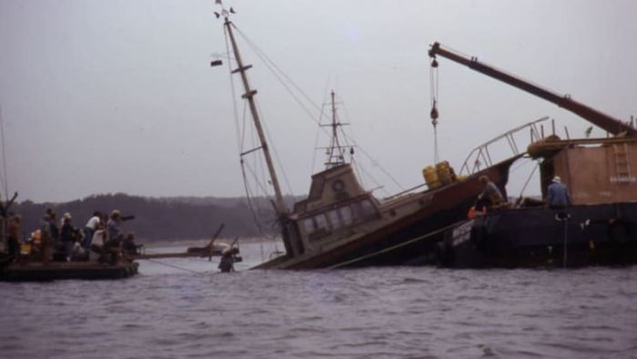 The Orca II sinks on cue as the crew watches during the filming of Jaws.