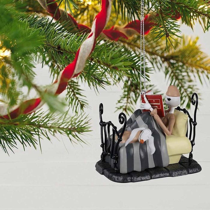 Christmas ornament featuring Jack Skellington reading 'A Christmas Carol' in bed
