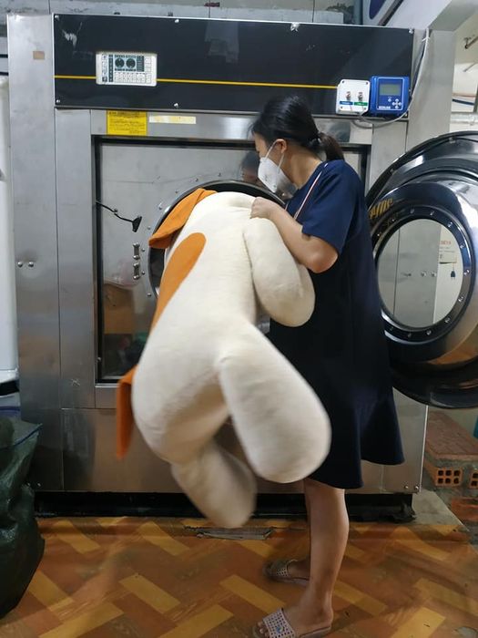 Hình ảnh đội ngũ chuyên viên đang thực hiện quy trình giặt là thân thiện môi trường