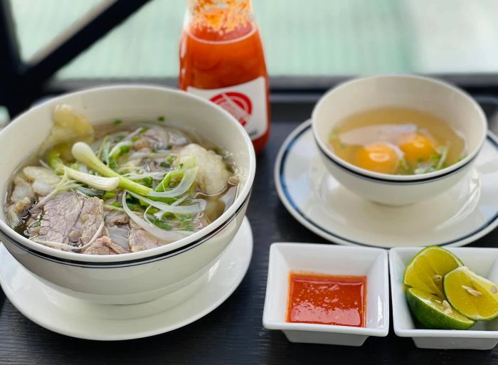Hình ảnh tô phở Hoàng chuẩn vị - nước dùng trong vắt, thịt bò tươi hồng, hành lá xanh mướt