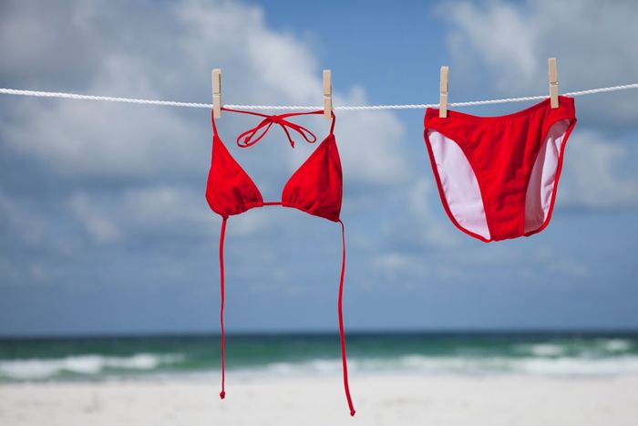 A red bikini hanging on a clothesline
