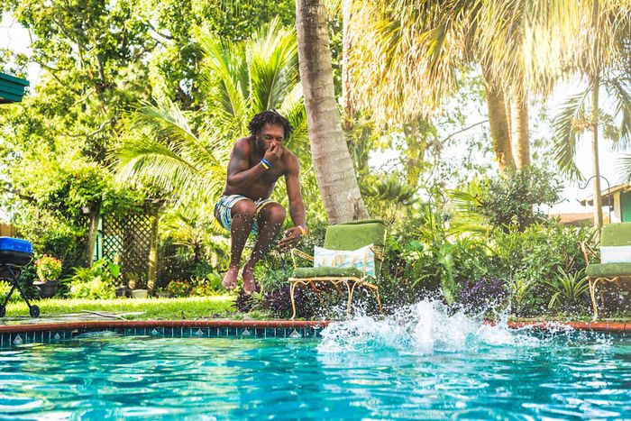Photo of a man leaping into a pool in Florida