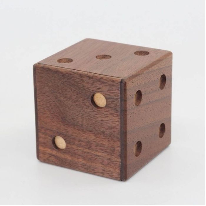 A puzzle box resembling a die.