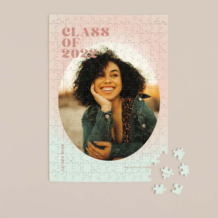 A custom graduation puzzle displayed on a tan background with scattered puzzle pieces