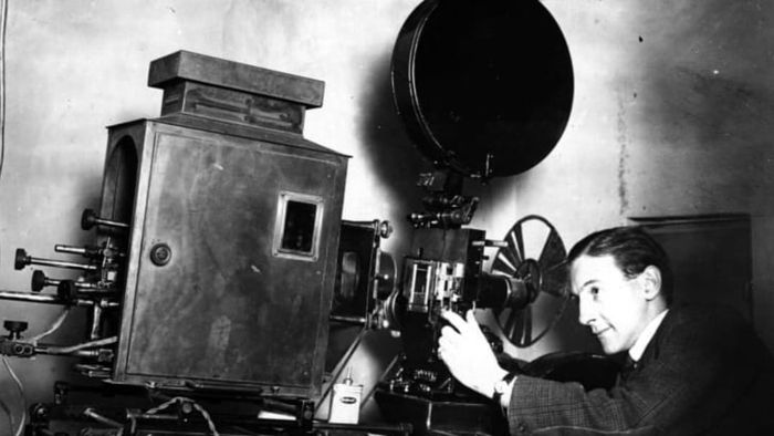 A projectionist operating in a local cinema, circa 1930.
