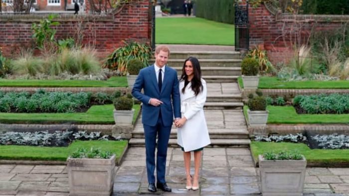 Prince Harry and Meghan Markle are photographed in the Sunken Garden at Kensington Palace in west London on November 27, 2017, following their engagement announcement