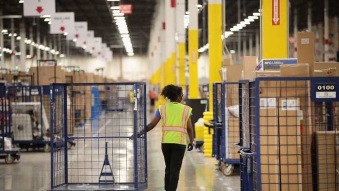 Amazon warehouse workers are closely monitored through handheld devices.