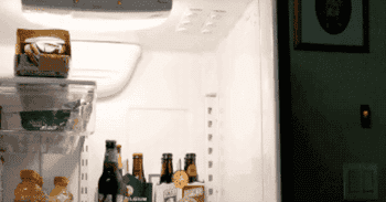 A gif showing someone attaching a six-pack of beers to the magnets using the cardboard holder that comes with the beers