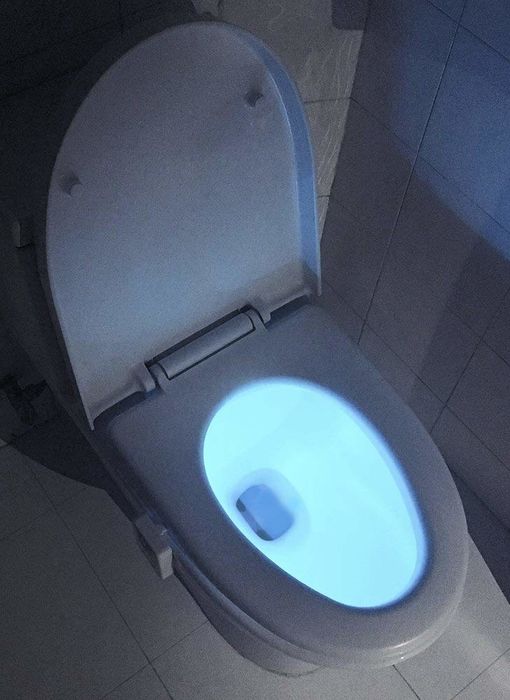 A glowing blue toilet night-light