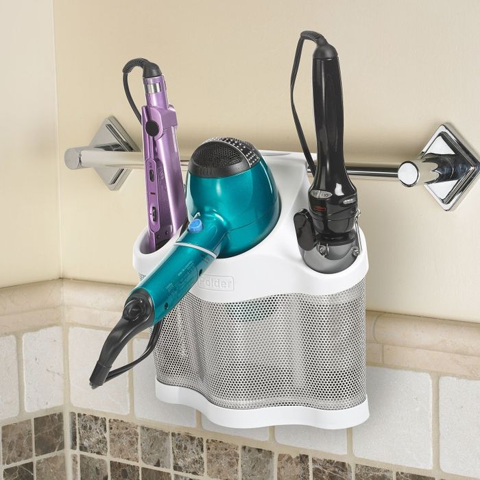 The styling station holding hair tools and hanging on a towel rack.