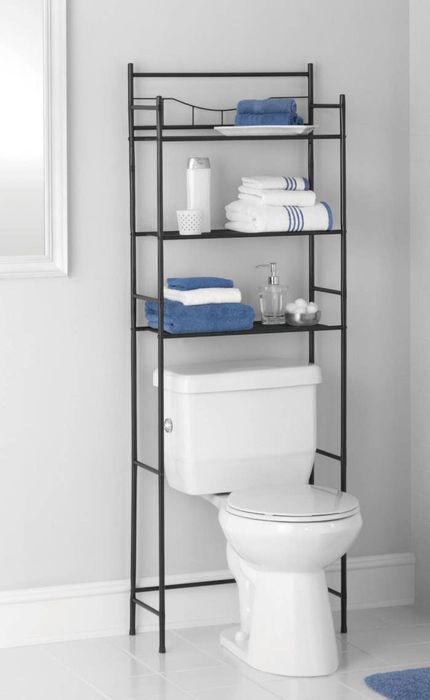 The shelf holding various items above the toilet