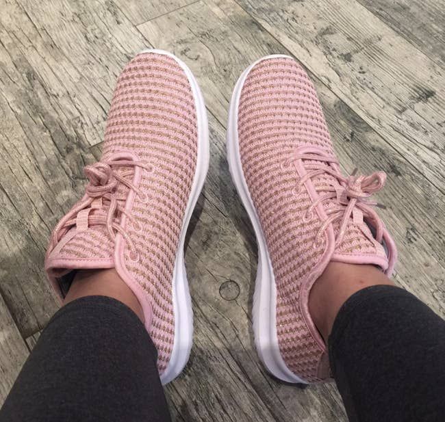 reviewer wearing the pink knit lace-up sneakers