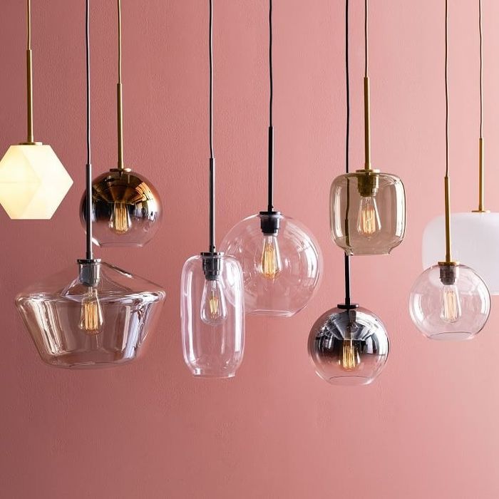 Several glass pendant lights hanging down