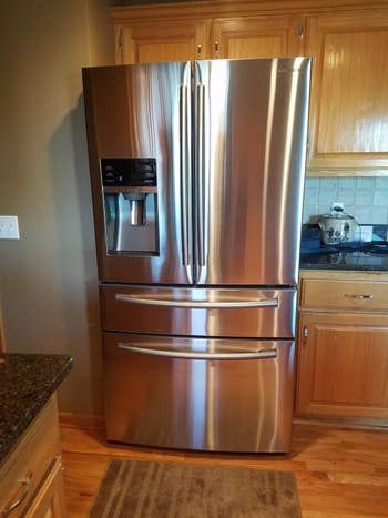A review image showcasing a gleaming, spotless stainless steel fridge.