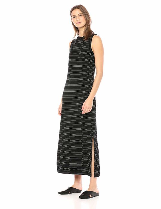 The model wears the striped dress with a side slit.