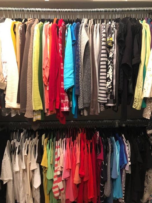 A reviewer's closet, packed with clothes, all neatly hung thanks to the slim hangers.