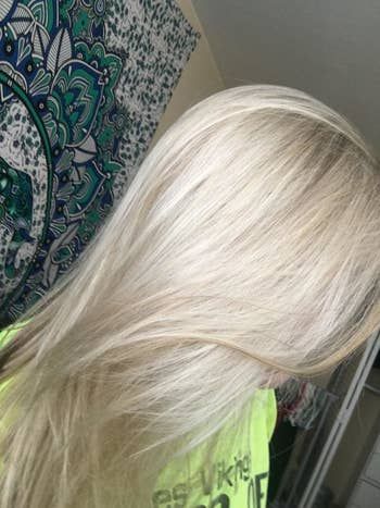 The same reviewer's hair now transformed into a cool, platinum blonde shade