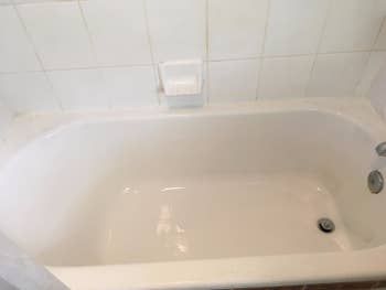 Reviewer photo showing the same tub spotless and cleaned after using the brush kit