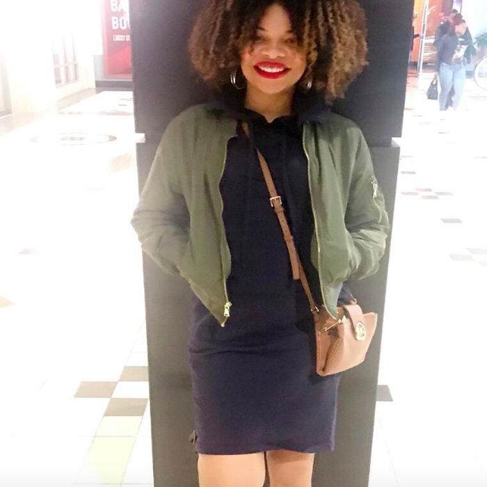 A customer review photo of them modeling the black dress