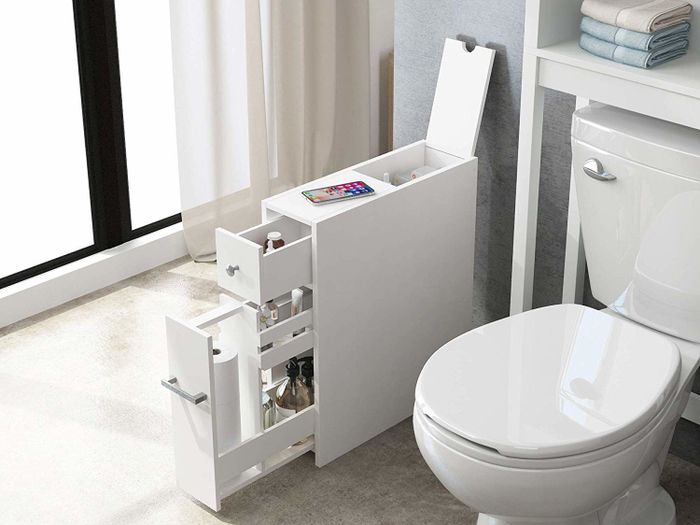 The cabinet with its drawers open, displaying the variety of items it can store beside the toilet