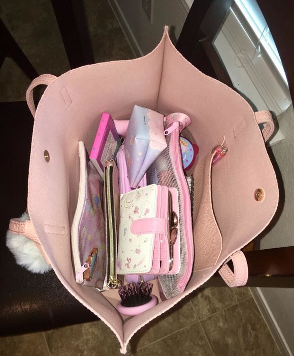 Image from a reviewer showcasing the spacious interior of a pink tote bag, complete with a pocket for organizing belongings.