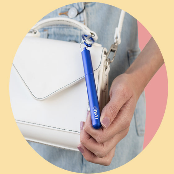 A model showcasing a purse with a keychain attached to it
