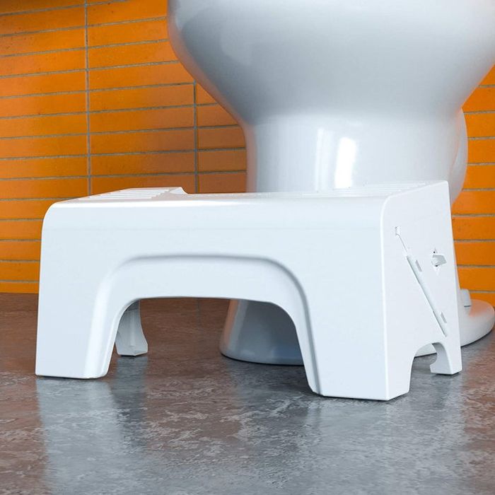 A compact stool placed in front of a toilet for easy access.