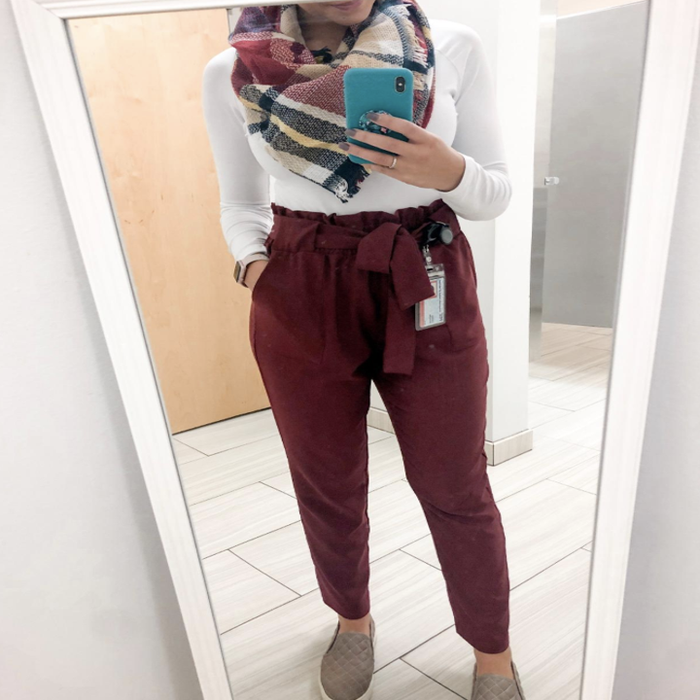 Reviewer wearing a plaid red, green, and white scarf