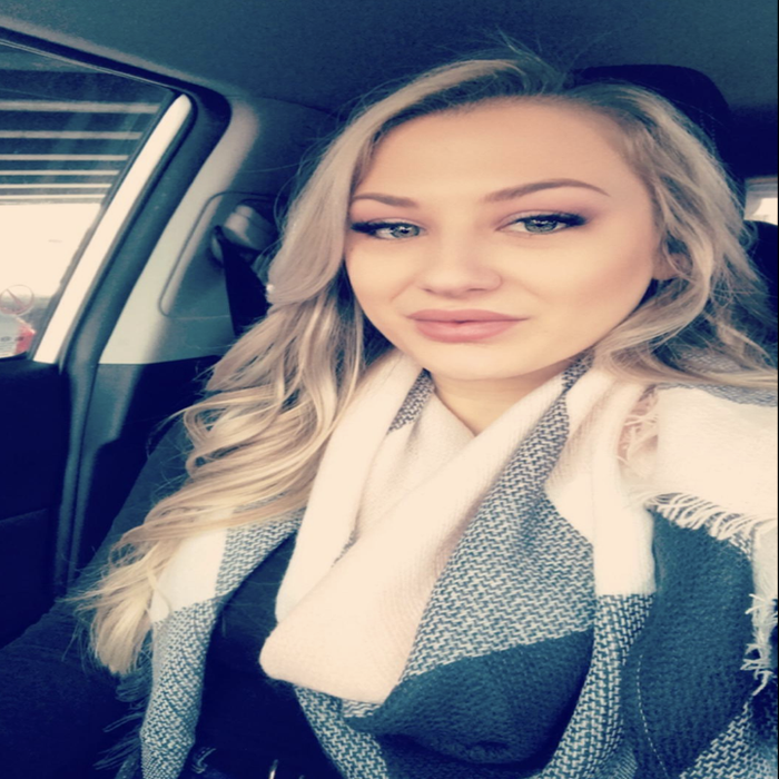 Reviewer wearing a black and white plaid scarf
