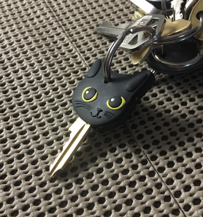 A black silicone cat-shaped key cover hanging from a keychain