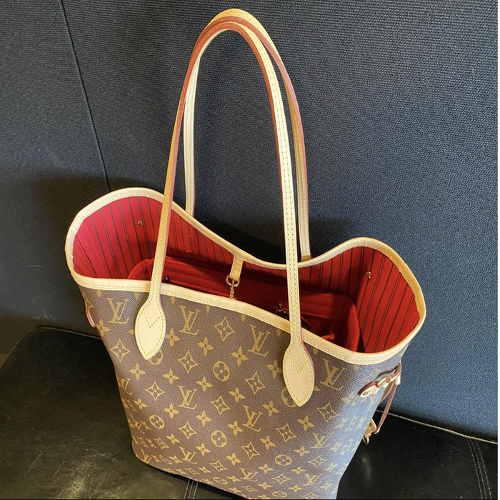 The tote bag resting on the floor, with the red felt organizer insert hidden inside