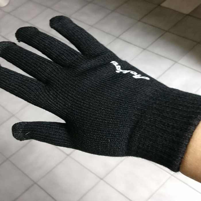 Same reviewer displaying the plain black backside of the gloves