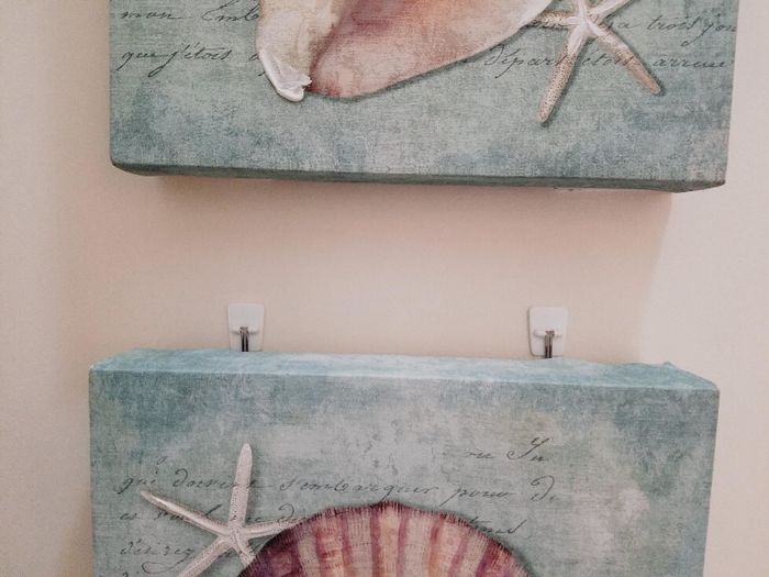 Artwork on canvas suspended by the hooks.