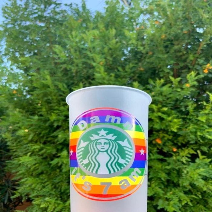A colorful Starbucks cup featuring a rainbow design and the iconic mermaid logo, accompanied by the phrase