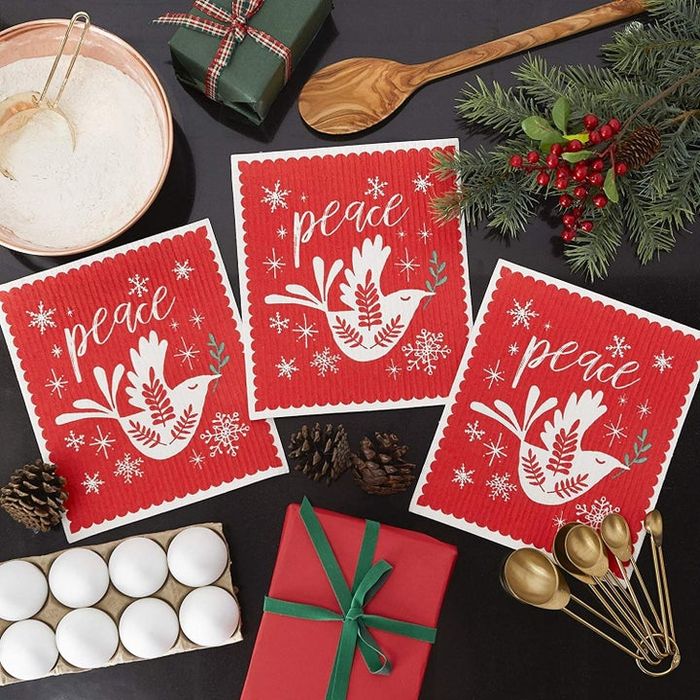 Three red garments with a white dove and the word
