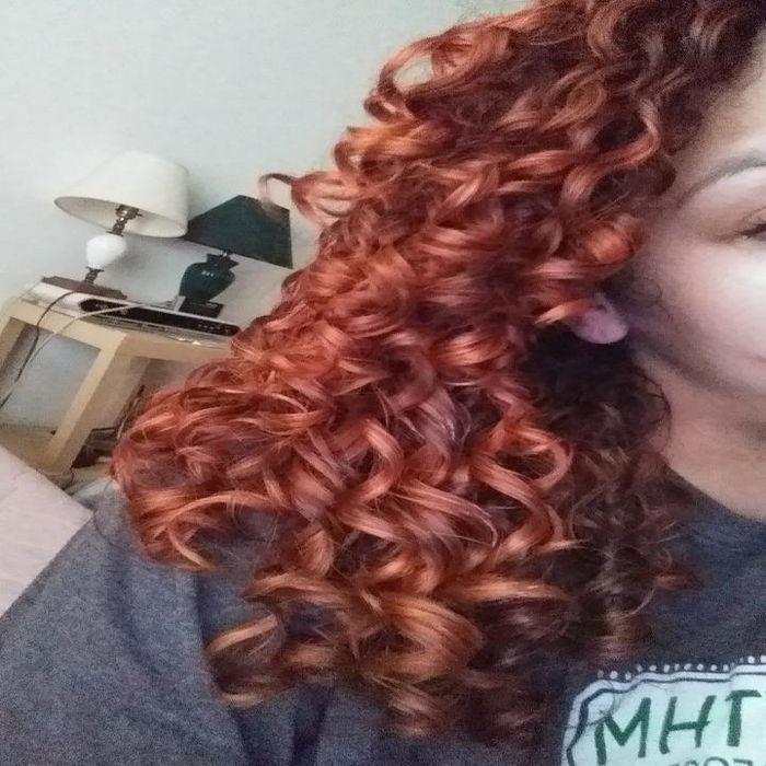 Reviewer showing their curly hair before using the hot air brush