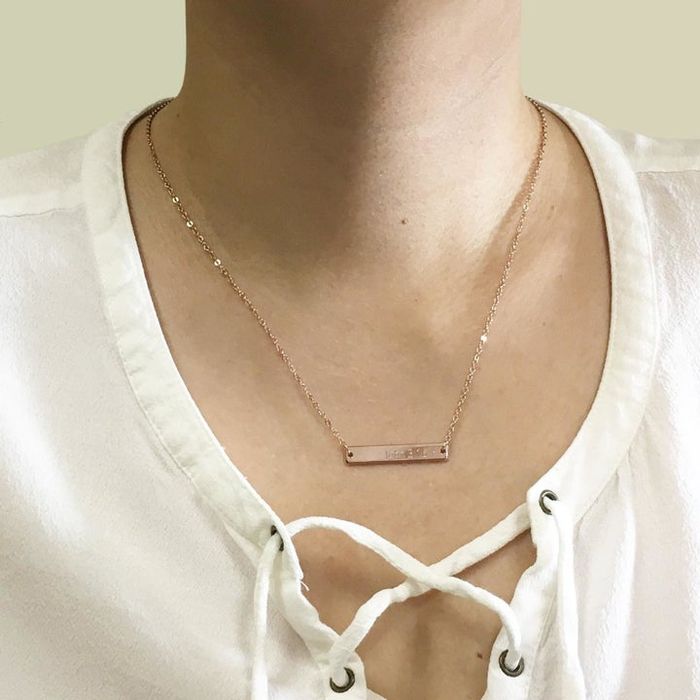 Model wearing the engraved necklace