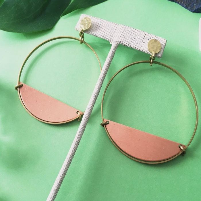 Close-up product image of earrings with half-circle copper accents