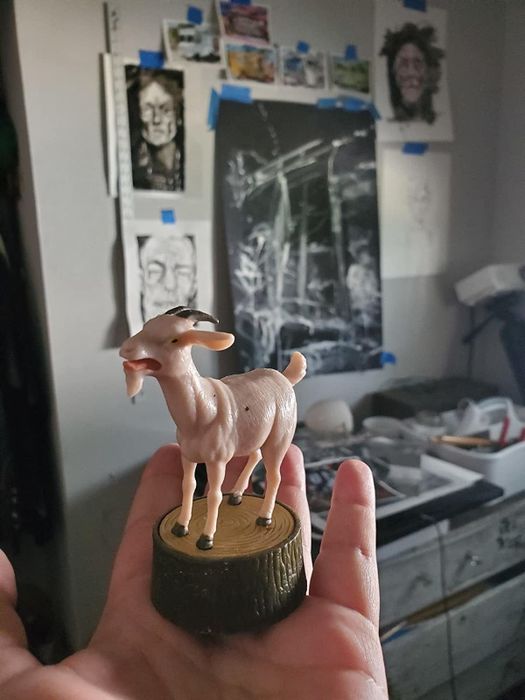 The little goat toy resting on a reviewer’s hand