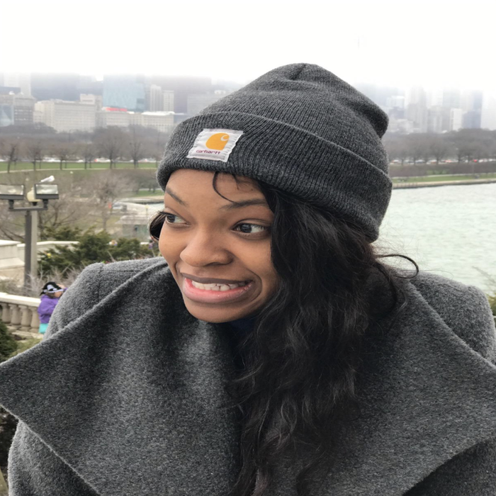 Reviewer wearing a gray fold-over beanie with the Carhartt logo stitched on the front