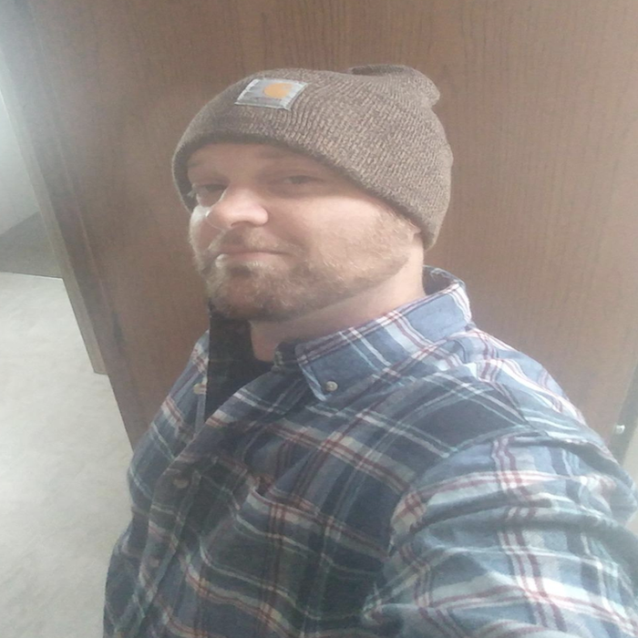 A reviewer wearing the beige version of the Carhartt beanie