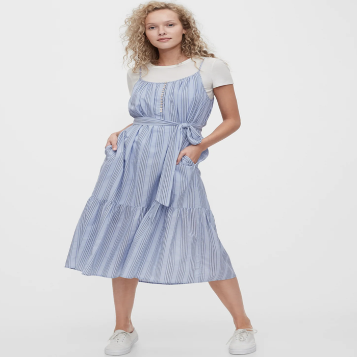 Model showcasing a shirred blue stripe cami dress