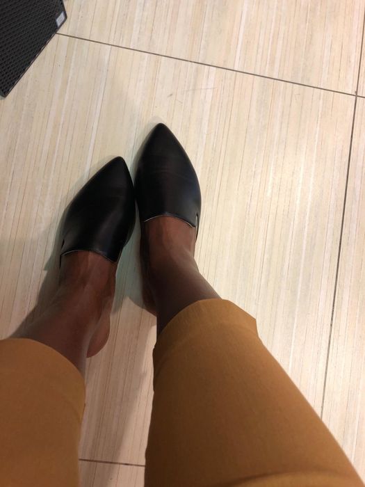 A reviewer modeling the mules in a sleek black color
