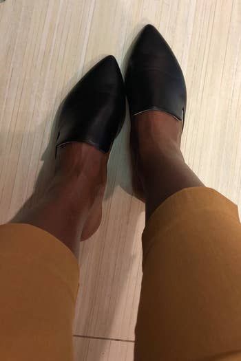 A reviewer modeling the mules in a sleek black color