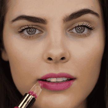 A gif of a model applying the lip balm.