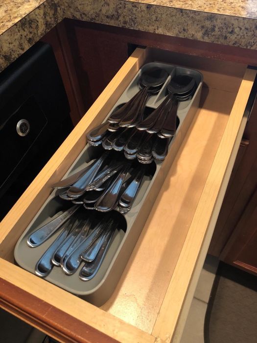 A photo from a reviewer showing an open drawer with all their silverware neatly arranged using a drawer organizer.