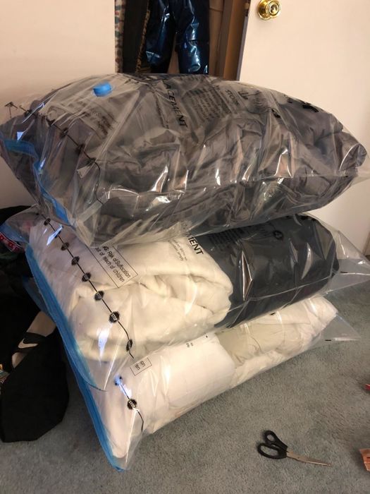 A reviewer's comforters and pillows neatly packed into pre-flattened jumbo space saver bags, saving space and reducing clutter.